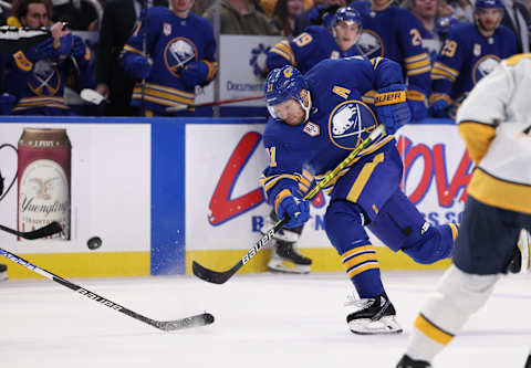 Apr 1, 2022; Buffalo, New York, USA; Buffalo Sabres right wing Kyle Okposo (21) takes a shot on goal during the second period against the Nashville Predators at KeyBank Center. Mandatory Credit: Timothy T. Ludwig-USA TODAY Sports