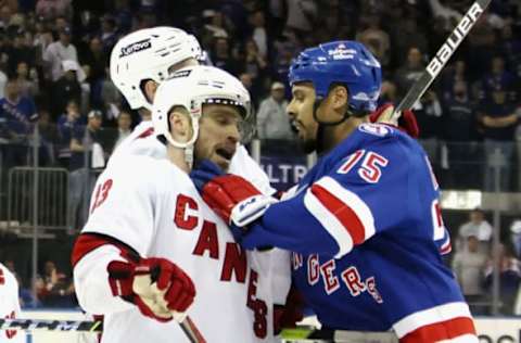 NEW YORK, NEW YORK – MAY 24: Ryan Reaves #75 of the New York Rangers confronts Max Domi #13 of the Carolina Hurricanes near the end of their game in Game Four of the Second Round of the 2022 Stanley Cup Playoffs at Madison Square Garden on May 24, 2022, in New York City. The Rangers defeated the Hurricanes 4-1. (Photo by Bruce Bennett/Getty Images)