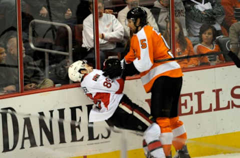 Nov 19, 2013; Philadelphia, PA, USA; Philadelphia Flyers defenseman Braydon Coburn (5) checks Ottawa Senators left wing Cory Conacher (89) during the second period at Wells Fargo Center. Mandatory Credit: Eric Hartline-USA TODAY Sports