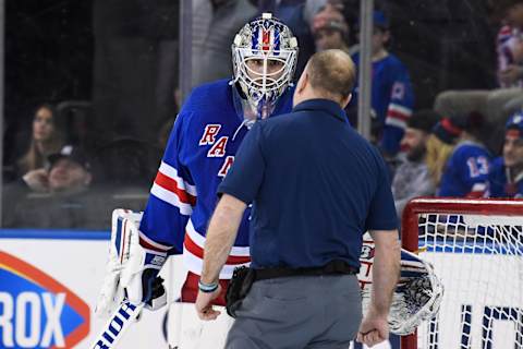 Feb 15, 2022; New York, New York, USA; New York Rangers trainer talks to New York Rangers goaltender Igor Shesterkin (31) after hitting his head on the ice during overtime at Madison Square Garden. Mandatory Credit: Dennis Schneidler-USA TODAY Sports