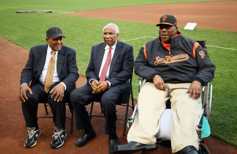 SAN FRANCISCO, CA – SEPTEMBER 13: (L-R) Baseball Hall of Fame members Willie Mays, Frank Robinson, and Willie McCovey sit on the field before the San Francisco Giants game against the Los Angeles Dodgers at AT