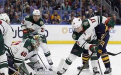 Oct 27, 2016; Buffalo, NY, USA; Minnesota Wild left wing Teemu Pulkkinen (17) clears the puck in front of goalie Devan Dubnyk (40) during the second period against the Buffalo Sabres at KeyBank Center. Mandatory Credit: Timothy T. Ludwig-USA TODAY Sports