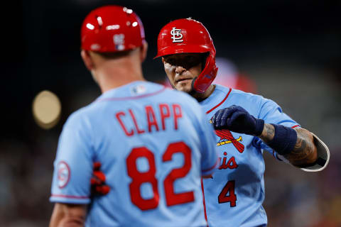 Jul 3, 2021; Denver, Colorado, USA; St. Louis Cardinals catcher Yadier Molina (4) reacts with first base coach Stubby Clapp (82) after hitting an RBI single in the eighth inning against the Colorado Rockies at Coors Field. Mandatory Credit: Isaiah J. Downing-USA TODAY Sports