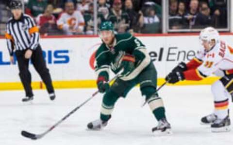 Apr 9, 2016; Saint Paul, MN, USA; Minnesota Wild defenseman Christian Folin (5) skates with the puck in the third period against the Calgary Flames forward Mikael Backlund (11) at Xcel Energy Center. Mandatory Credit: Brad Rempel-USA TODAY Sports