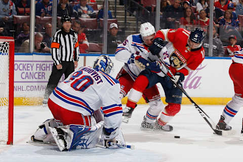 Libor Hajek #25 checks Jonathan Huberdeau #11 of the Florida Panthers. (Photo by Joel Auerbach/Getty Images)