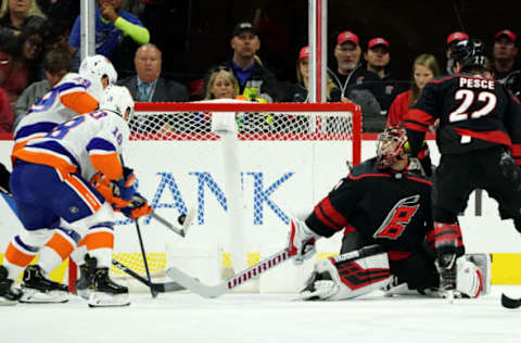 RALEIGH, NC – OCTOBER 11: Brock Nelson #29 of the New York Islanders chips the puck past the defense of Petr Mrazek #34 of the Carolina Hurricanes during an NHL game on October 11, 2019 at PNC Arena in Raleigh North Carolina. (Photo by Gregg Forwerck/NHLI via Getty Images)