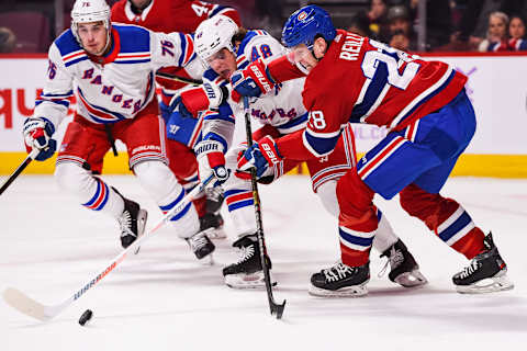 MONTREAL, QC – NOVEMBER 23: Montreal Canadiens defenceman Mike Reilly (28) and New York Rangers left wing Brendan Lemieux (48) battle for control of the puck during the New York Rangers versus the Montreal Canadiens game on November 23, 2019, at Bell Centre in Montreal, QC (Photo by David Kirouac/Icon Sportswire via Getty Images)