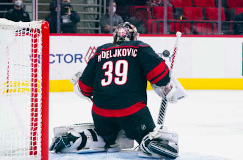 Apr 3, 2021; Raleigh, North Carolina, USA; Carolina Hurricanes goaltender Alex Nedeljkovic (39) makes a first period save against the Dallas Stars at PNC Arena. Mandatory Credit: James Guillory-USA TODAY Sports