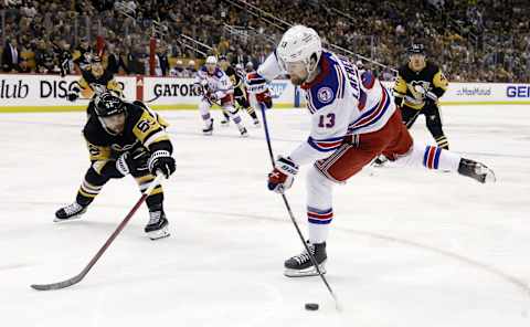 May 13, 2022; Pittsburgh, Pennsylvania, USA; New York Rangers left wing Alexis Lafrenière (13) shoots the puck as Pittsburgh Penguins defenseman Kris Letang (58) defends during the third period in game six of the first round of the 2022 Stanley Cup Playoffs at PPG Paints Arena. The Rangers won 5-3. Mandatory Credit: Charles LeClaire-USA TODAY Sports