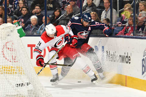 COLUMBUS, OH – NOVEMBER 10: Jaccob Slavin #74 of the Carolina Hurricanes and Boone Jenner #38 of the Columbus Blue Jackets battle for the puck against the boards during the first period of a game on November 10, 2017 at Nationwide Arena in Columbus, Ohio. (Photo by Jamie Sabau/NHLI via Getty Images)