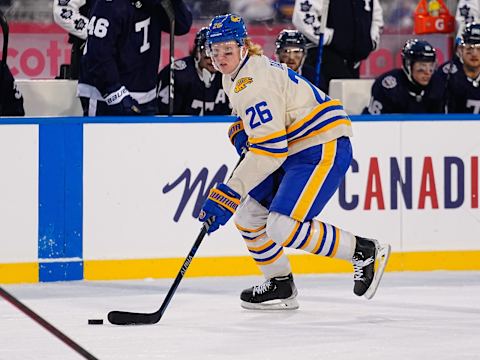 Mar 13, 2022; Hamilton, Ontario, CAN; Buffalo Sabres defenseman Rasmus Dahlin (26) carries the puck against the Toronto Maple Leafs in the 2022 Heritage Classic ice hockey game at Tim Hortons Field. Mandatory Credit: John E. Sokolowski-USA TODAY Sports