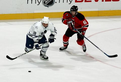 EAST RUTHERFORD, NJ – MARCH 26: Tommy Albelin #6 of the New Jersey Devils challenges Tie Domi #28  (Photo by Mike Stobe/Getty Images)