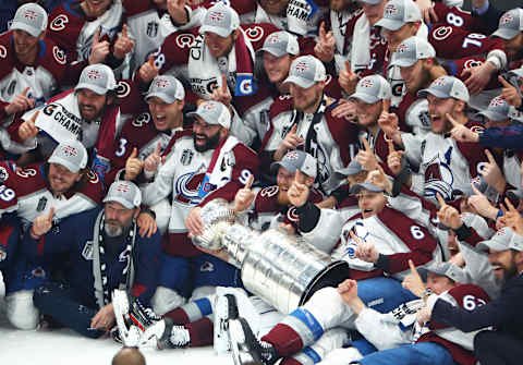 Jun 26, 2022; Tampa, Florida, USA; The Colorado Avalanche pose for a team photo with the Stanley Cup trophy after defeating the Tampa Bay Lightning to win the Stanley Cup in game six of the 2022 Stanley Cup Final at Amalie Arena. Mandatory Credit: Mark J. Rebilas-USA TODAY Sports