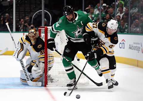 DALLAS, TEXAS – OCTOBER 03: Jamie Benn #14 of the Dallas Stars skates for the puck against Torey Krug #47 of the Boston Bruins in the first period at American Airlines Center on October 03, 2019 in Dallas, Texas. (Photo by Ronald Martinez/Getty Images)