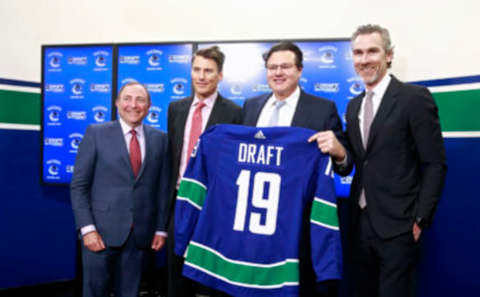 VANCOUVER, BC – FEBRUARY 28: (L-R) NHL Commissioner Gary Bettman, Vancouver Mayor Gregor Robertson, Francesco Aquilini, Vancouver Canucks Chairman and Governor and Trevor Linden, Vancouver Canucks President Hockey Operations hold a 2019 Vancouver Canucks 2019 Draft jersey during a press conference at Rogers Arena February 28, 2018 in Vancouver, British Columbia, Canada. The Vancouver Canucks will host the 2019 NHL Draft at Rogers Arena, the National Hockey League, Canucks and City of Vancouver announced today. (Photo by Jeff Vinnick/NHLI via Getty Images)