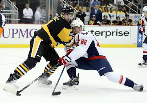 Oct 13, 2016; Pittsburgh, PA, USA; Pittsburgh Penguins defenseman Justin Schultz (4) defends Washington Capitals defenseman Nate Schmidt (88) during the third period against at the PPG Paints Arena. The Penguins won 3-2 in a shootout. Mandatory Credit: Charles LeClaire-USA TODAY Sports