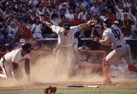 ANAHEIM – OCTOBER 12: Home Plate Umpire Rocky Roe (center) calls Ruppert Jones #13 (left) of the California Angels safe after an attempted tag by catcher Rich Gedman #10 (right) of the Boston Red Sox in the bottom of the ninth inning of Game 5 of the 1986 ALCS played on October 12, 1986 at Anaheim Stadium in Anaheim, California. (Photo by David Madison/Getty Images)