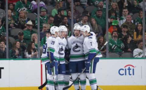 DALLAS, TX – MARCH 17: Ashton Sauter #29, Elias Pettersson #40, Tim Schaller #59 and Luke Schenn #2 of the Vancouver Canucks celebrate a goal against the Dallas Stars at the American Airlines Center on March 17, 2019 in Dallas, Texas. (Photo by Glenn James/NHLI via Getty Images)