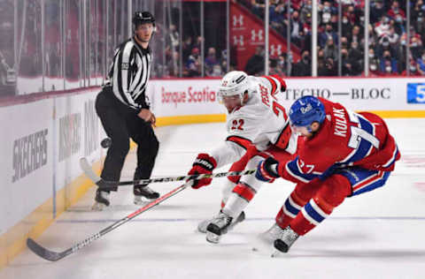 MONTREAL, QC – OCTOBER 21: Brett Pesce #22 of the Carolina Hurricanes and Brett Kulak #77 of the Montreal Canadiens skate after the puck during the first period at Centre Bell on October 21, 2021, in Montreal, Canada. (Photo by Minas Panagiotakis/Getty Images)