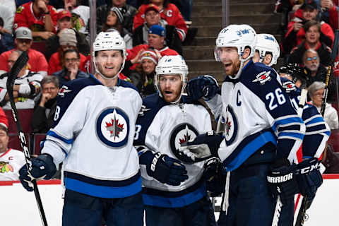 CHICAGO, IL – DECEMBER 04: (L-R) Jacob Trouba #8 , Bryan Little #18 and Blake Wheeler #26 of the Winnipeg Jets react after Little scored against the Chicago Blackhawks in the second period at the United Center on December 4, 2016 in Chicago, Illinois. (Photo by Bill Smith/NHLI via Getty Images)