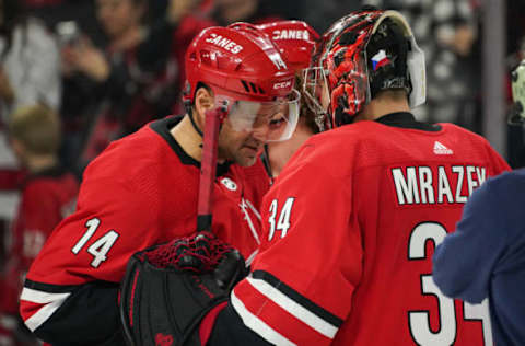 RALEIGH, NC – JANUARY 21: Carolina Hurricanes Right Wing Justin Williams (14) congratulates Carolina Hurricanes Goalie Petr Mrazek (34) after a game between the Carolina Hurricanes and the Winnipeg Jets on January 21, 2020 at the PNC Arena in Raleigh, NC. (Photo by Greg Thompson/Icon Sportswire via Getty Images)