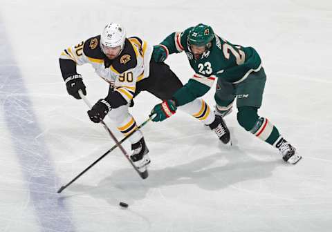 ST. PAUL, MN – APRIL 04: Marcus Johansson #90 of the Boston Bruins and J.T. Brown #23 of the Minnesota Wild battle for the puck during a game at Xcel Energy Center on April 4, 2019 in St. Paul, Minnesota.(Photo by Bruce Kluckhohn/NHLI via Getty Images)