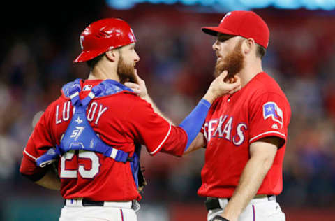 Sep 30, 2016; Arlington, TX, USA; Texas Rangers catcher Jonathan Lucroy (25) touches the beard of relief pitcher Sam Dyson (47) after the game against the Tampa Bay Rays at Globe Life Park in Arlington. Texas won 3-1. Mandatory Credit: Tim Heitman-USA TODAY Sports