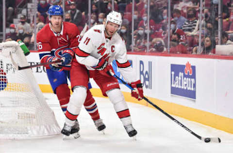 MONTREAL, QC – OCTOBER 21: Jordan Staal #11 of the Carolina Hurricanes skates the puck against Jeff Petry #26 of the Montreal Canadiens during the first period at Centre Bell on October 21, 2021, in Montreal, Canada. The Carolina Hurricanes defeated the Montreal Canadiens 4-1. (Photo by Minas Panagiotakis/Getty Images)