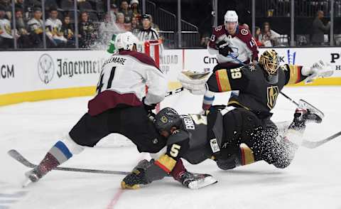 LAS VEGAS, NEVADA – DECEMBER 23: Deryk Engelland #5 of the Vegas Golden Knights crashes into Pierre-Edouard Bellemare #41 of the Colorado Avalanche as Marc-Andre Fleury #29 of the Golden Knights defends the net in the third period of their game at T-Mobile Arena on December 23, 2019 in Las Vegas, Nevada. The Avalanche defeated the Golden Knights 7-3. (Photo by Ethan Miller/Getty Images)