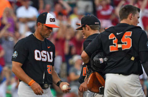 Omaha, NE – JUNE 26: Pitching coach Nate Yeskie #21 of the Oregon State Beavers takes out pitcher pitcher Luke Heimlich #15 in the fifth inning against the Arkansas Razorbacks during game one of the College World Series Championship Series on June 26, 2018 at TD Ameritrade Park in Omaha, Nebraska. (Photo by Peter Aiken/Getty Images)