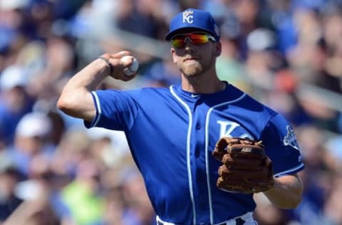 Mar 13, 2016; Surprise, AZ, USA; Kansas City Royals third baseman Hunter Dozier (60) throws the ball to first base during the second inning against the Cleveland Indians at Surprise Stadium. Mandatory Credit: Joe Camporeale-USA TODAY Sports