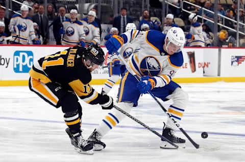 Sep 28, 2023; Pittsburgh, Pennsylvania, USA; Pittsburgh Penguins forward Alex Nylander (11) defends Buffalo Sabres defenseman Nikita Novikov (91) during the third period against at PPG Paints Arena. Pittsburgh won 3-1. Mandatory Credit: Charles LeClaire-USA TODAY Sports