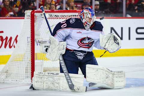 Jan 23, 2023; Calgary, Alberta, CAN; Columbus Blue Jackets goaltender Joonas Korpisalo (70) makes a save against the Calgary Flames during the overtime period at Scotiabank Saddledome. Mandatory Credit: Sergei Belski-USA TODAY Sports