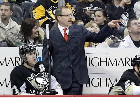 Feb 3, 2014; Pittsburgh, PA, USA; Pittsburgh Penguins head coach Dan Bylsma (right) gestures on the bench against the Ottawa Senators during the second period at the CONSOL Energy Center. Mandatory Credit: Charles LeClaire-USA TODAY Sports