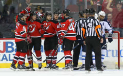 Mar 28, 2017; Newark, NJ, USA; New Jersey Devils right wing Beau Bennett (8) celebrates with teammates (Ed Mulholland-USA TODAY Sports)