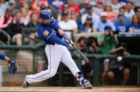 Mar 5, 2017; Surprise, AZ, USA; Texas Rangers catcher Jonathan Lucroy (25) hits a single against the Chicago Cubs during the second inning at Surprise Stadium. Mandatory Credit: Joe Camporeale-USA TODAY Sports