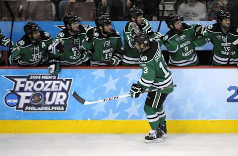 Apr 10, 2014; Philadelphia, PA, USA; North Dakota Sioux forward Connor Gaarder (13) celebrates his goal with against the Minnesota Gophers during the third period in the semifinals of the Frozen Four college ice hockey tournament at Wells Fargo Center. Minnesota defeated North Dakota, 2-1. Mandatory Credit: Eric Hartline-USA TODAY Sports