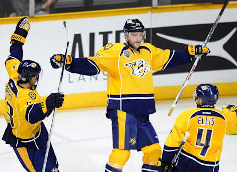 Oct 22, 2015; Nashville, TN, USA; Nashville Predators defenseman Mattias Ekholm (14) celebrates with center Mike Ribeiro (63) and defenseman Ryan Ellis (4) after scoring during the third period against the Anaheim Ducks at Bridgestone Arena. The Predators won 5-1. Mandatory Credit: Christopher Hanewinckel-USA TODAY Sports