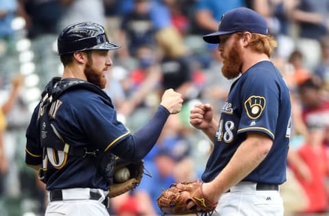 May 29, 2016; Milwaukee, WI, USA; Milwaukee Brewers catcher Jonathan Lucroy (20) and pitcher 