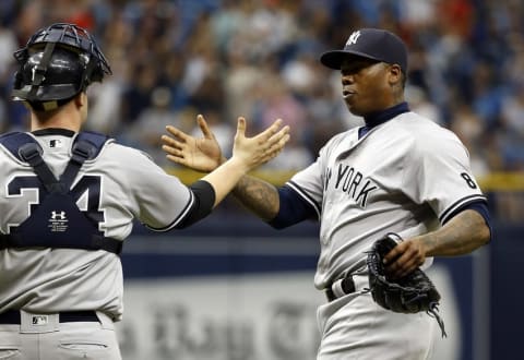 May 29, 2016; St. Petersburg, FL, USA; New York Yankees relief pitcher Aroldis Chapman (54) and catcher Brian McCann (34) high five after defeating the Tampa Bay Rays at Tropicana Field. The Yankees beat the Rays 2-1. Mandatory Credit: Kim Klement-USA TODAY Sports. MLB.