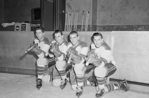 Here are the four sharpshooters of the New York Rangers who are expected to score 100 goals for the season as they paused during a workout at Madison Square Garden today. From left: Andy Bathgate, Dean Prentice, Danny Lewicki, and Wally Hergesheimer. The Rangers show every sign of going to town this year. The won their NHL opener for the first time in eight years at Chicago and licked the Detroit Red Wings for the first time since the 1953-54 season.