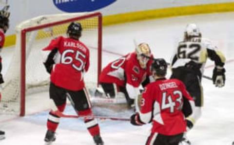 Apr 5, 2016; Ottawa, Ontario, CAN; Pittsburgh Penguins left wing Carl Hagelin (62) scores against Ottawa Senators goalie Andrew Hammond (30) in the third period at the Canadian Tire Centre. The Penguins defeated the Senators 5-3. Mandatory Credit: Marc DesRosiers-USA TODAY Sports