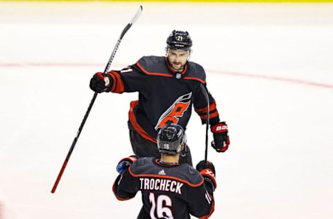 TORONTO, ONTARIO – AUGUST 15: Nino Niederreiter #21 of the Carolina Hurricanes is congratulated by his teammate, Vincent Trocheck #16 after scoring a goal against the Boston Bruins during the third period in Game Three of the Eastern Conference First Round during the 2020 NHL Stanley Cup Playoffs at Scotiabank Arena on August 15, 2020, in Toronto, Ontario. (Photo by Elsa/Getty Images)