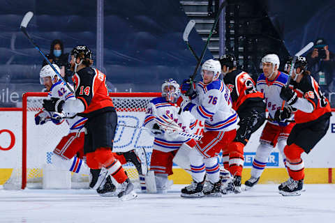 New York Rangers and Philadelphia Flyers chase the puck during the second period at Wells Fargo Center on February 24, 2021 in Philadelphia, Pennsylvania. (Photo by Tim Nwachukwu/Getty Images)