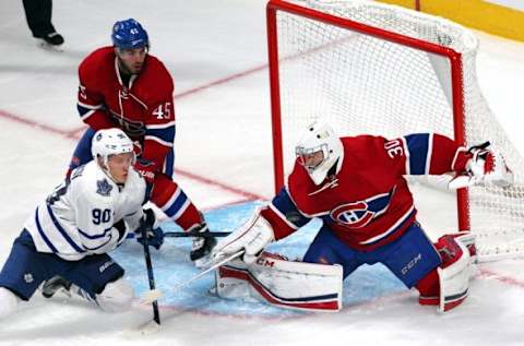 Sep 22, 2015; Montreal, Quebec, CAN; Montreal Canadiens goalie Zachary Fucale (30) makes a save against Toronto Maple Leafs right wing Nikita Shisnikov (90) as defenseman Mark Barberio (45) defends during the third period at Bell Centre. Mandatory Credit: Jean-Yves Ahern-USA TODAY Sports