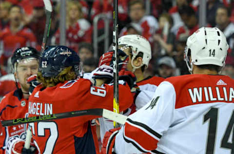 WASHINGTON, DC – APRIL 11: Washington Capitals left wing Carl Hagelin (62) tussles with Carolina Hurricanes right wing Nino Niederreiter (21) in the first period on April 11, 2019, at the Capital One Arena in Washington, D.C. in the first round of the Stanley Cup Playoffs. (Photo by Mark Goldman/Icon Sportswire via Getty Images)