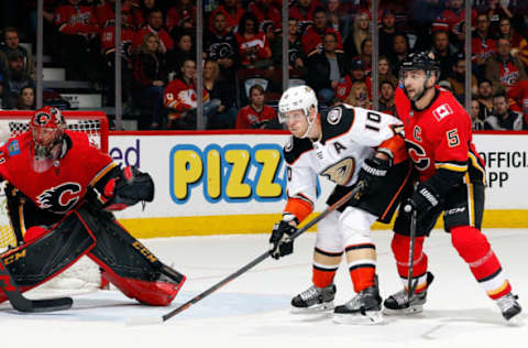 CALGARY, AB: Mark Giordano #5 of the Calgary Flames skates against Corey Perry #10 of the Anaheim Ducks during an NHL game on January 6, 2018. (Photo by Brad Watson/NHLI via Getty Images)