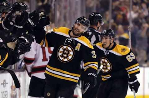 Oct 20, 2016; Boston, MA, USA; Boston Bruins center Patrice Bergeron (37) is followed by left wing Brad Marchand (63) after Bergeron scored the winning goal during the third period of the Boston Bruins 2-1 win over the New Jersey Devils at TD Garden. Mandatory Credit: Winslow Townson-USA TODAY Sports