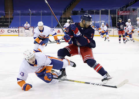 Feb 8, 2021; New York, NY, USA; K’Andre Miller #79 of the New York Rangers trips up Mathew Barzal #13 of the New York Islanders during the third period at Madison Square Garden on February 08, 2021 in New York City. Mandatory Credit: Bruce Bennett/Pool Photo-USA TODAY Sports