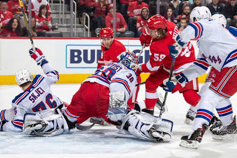 DETROIT, MI – FEBRUARY 1: Goaltender Henrik Lundqvist #30 of the New York Rangers makes a save on a shot by Tyler Bertuzzi #59 of the Detroit Red Wings as Dylan Larkin #71 of the Wings and Brady Skjei #76 of the Rangers look for the rebound during an NHL game at Little Caesars Arena on February 1, 2020 in Detroit, Michigan. (Photo by Dave Sandford/NHLI via Getty Images)